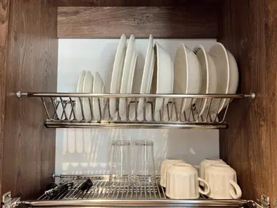 a shelf filled with plates and cups and dishes at SUITE DE LUJO FARO con Aire Acondicionado y Coworking in Medellín