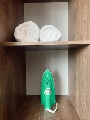 a green toilet in a cabinet with towels at SUITE DE LUJO FARO con Aire Acondicionado y Coworking in Medellín