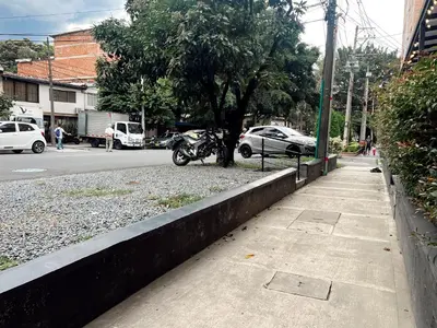 a motorcycle parked on the side of a street at SUITE DE LUJO FARO con Aire Acondicionado y Coworking in Medellín