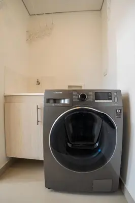 a washing machine is sitting in a kitchen at Cozy apt in Poblado The best area Great view in Medellín