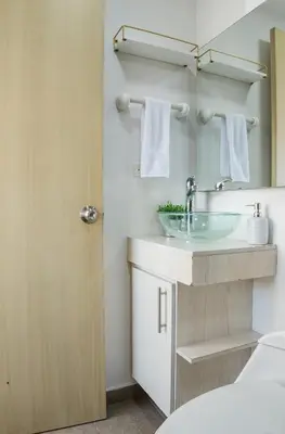 a bathroom with a sink and a mirror at Cozy apt in Poblado The best area Great view in Medellín