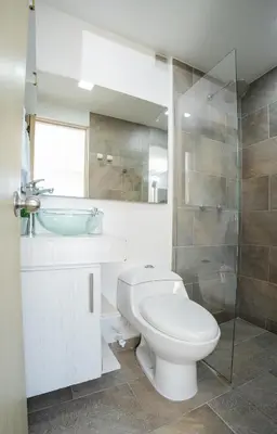 a bathroom with a toilet and a sink and a shower at Cozy apt in Poblado The best area Great view in Medellín