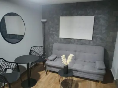 a living room with a couch and a table and a mirror at Apartamentos Acogedores Laureles in Medellín