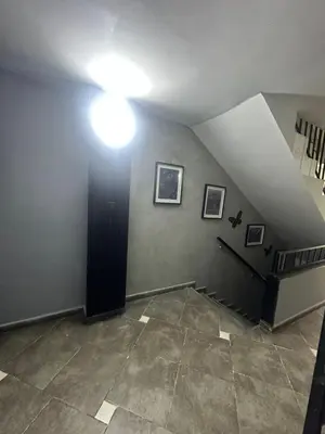 a room with a staircase with a light on the wall at Apartamentos Acogedores Laureles in Medellín