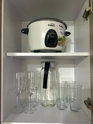 a shelf with wine glasses and a toaster on it at Comfortable and equipped apartment 5 minutes from the 70 Laureles in Medellín