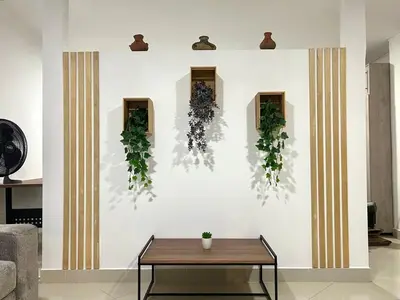 a room with a white wall with plants on it at Comfortable and equipped apartment 5 minutes from the 70 Laureles in Medellín