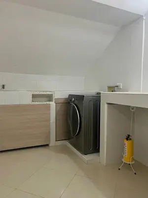 a washing machine in a kitchen with a counter at Comfortable and equipped apartment 5 minutes from the 70 Laureles in Medellín