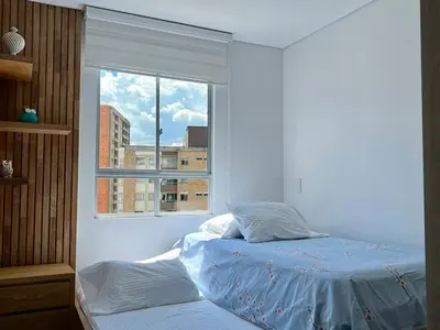a bedroom with a bed and a window at Moderno Apartamento Sabaneta - Century Tower II in Sabaneta