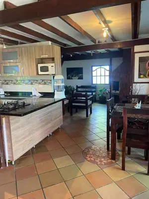 a kitchen with a counter and a dining room at Finca el Majagual in Guatapé