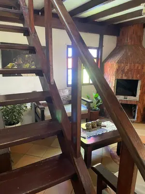 a wooden staircase in a room with a table at Finca el Majagual in Guatapé