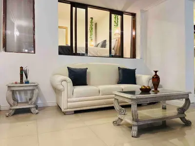 a living room with a couch and a table at Casa Amsterdam with Jacuzzi in Poblado Medellín in Medellín
