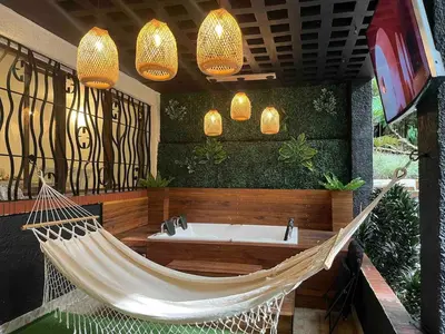 a hammock in a room with a tub at Casa Amsterdam with Jacuzzi in Poblado Medellín in Medellín