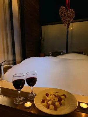 two glasses of wine and a plate of food on a table at Gampling el Cielo los pinos in Rionegro