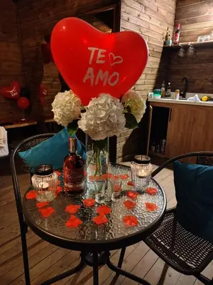 a table with a heart balloon and flowers on it at Gampling el Cielo los pinos in Rionegro