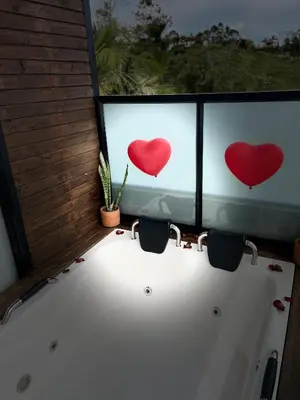 a bath tub with two hearts on the window at Gampling el Cielo los pinos in Rionegro