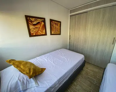 a bedroom with a bed with a pillow on it at Hermoso Apartamento Frente al Embalse 2 Habs View in Guatapé