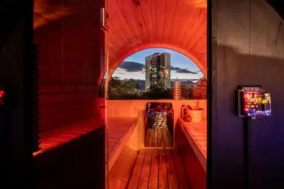 an open door to a balcony with a view of a city at Pool, Views, Sauna, Bar, Fire Pit and 24 HR Security in Medellín