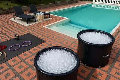 two trash cans sitting next to a swimming pool at Pool, Views, Sauna, Bar, Fire Pit and 24 HR Security in Medellín