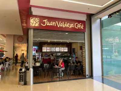 a restaurant with people sitting at tables in a mall at Home away from home - By Adri in Envigado