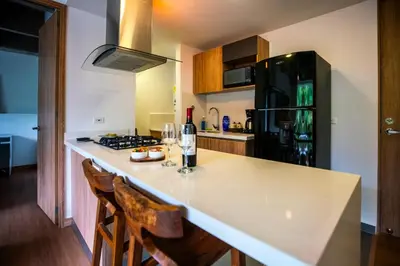 a kitchen with a large white counter top in a room at Home away from home - By Adri in Envigado