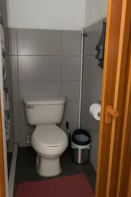 a small bathroom with a toilet and a trash can at Cozy 2BR in Prime El Poblado in Medellín