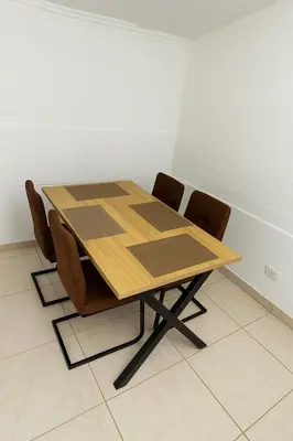 a wooden table and chairs in a room at Cozy 2BR in Prime El Poblado in Medellín