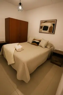a bedroom with a large bed with towels on it at Cozy 2BR in Prime El Poblado in Medellín