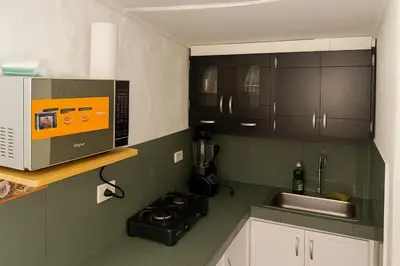 a kitchen with a sink and a microwave at Cozy 2BR in Prime El Poblado in Medellín