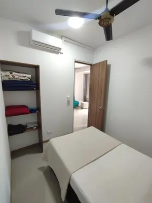 a white room with a bed and a closet at San Jeronimo - Apartamento - Hospedaje in San Jerónimo