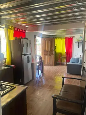 a kitchen with a refrigerator and a living room at CASA FINCA San Rque Antioquia in San Roque