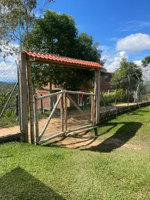 a wooden fence with a gate in the grass at CASA FINCA San Rque Antioquia in San Roque