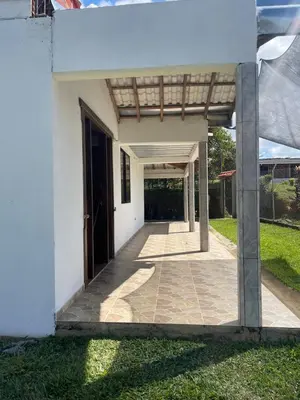 a white house with a door and a walkway at CASA FINCA San Rque Antioquia in San Roque