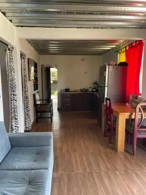 a kitchen and dining room with a table and a refrigerator at CASA FINCA San Rque Antioquia in San Roque