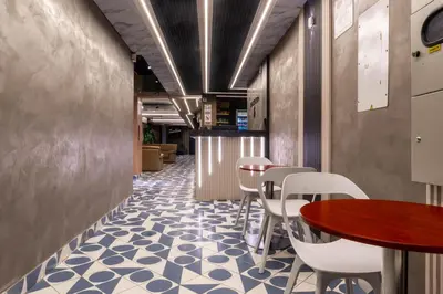 a restaurant with a blue and white floor and tables and chairs at hotel civitas medellin in Medellín