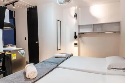 a room with a bed with two towels on it at hotel civitas medellin in Medellín