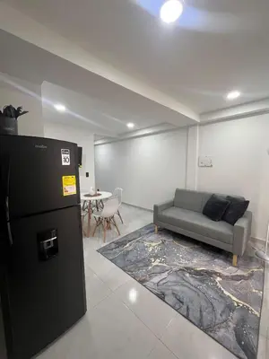a living room with a couch and a table at Apartamento en La America 2 habitaciones in Medellín