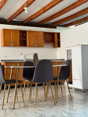 a dining room with black chairs and a table at Casa Madeira in Rionegro