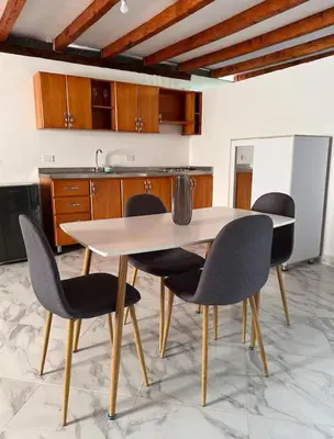 a kitchen with a white table and chairs at Casa Madeira in Rionegro