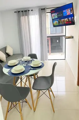 a dining room with a table and chairs and a tv at Casa moderna en el centro Carmen V WI-FI in Carmen de Viboral