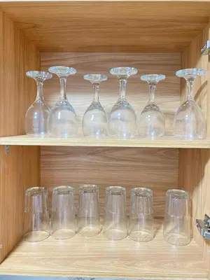 a row of wine glasses sitting on a shelf at Casa moderna en el centro Carmen V WI-FI in Carmen de Viboral
