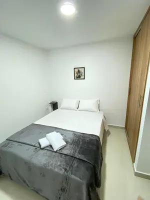 a bedroom with a large bed with two towels on it at Casa moderna en el centro Carmen V WI-FI in Carmen de Viboral