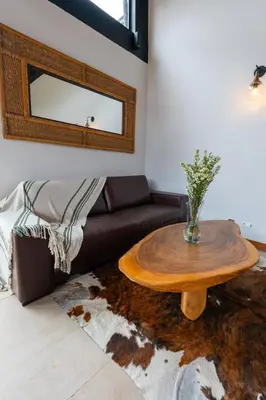 a living room with a table and a couch at Sahara Lodge Nature, Design Arabian Horses in El Retiro