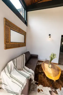 a living room with a couch and a wooden table at Sahara Lodge Nature, Design Arabian Horses in El Retiro