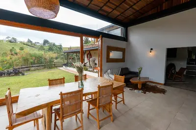 a dining room with a table and chairs and a large window at Sahara Lodge Nature, Design Arabian Horses in El Retiro