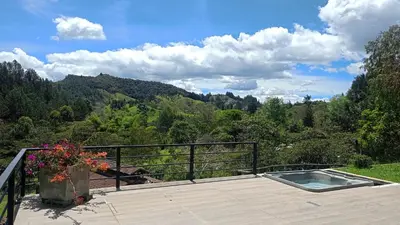 a hot tub on a deck with a view of the mountains at Sahara Lodge Nature, Design Arabian Horses in El Retiro