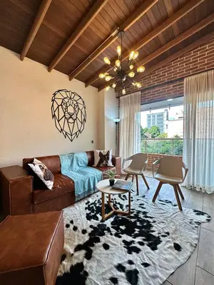 a living room with a couch and a table at Suitable unique design with natural light Envigado in Envigado