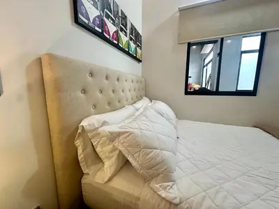 a bedroom with a white bed with a window at Suitable unique design with natural light Envigado in Envigado