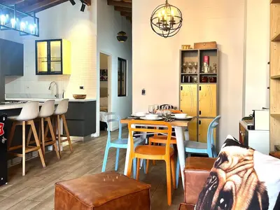 a kitchen and living room with a table and chairs at Suitable unique design with natural light Envigado in Envigado