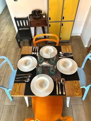 a table with plates and utensils on it at Suitable unique design with natural light Envigado in Envigado