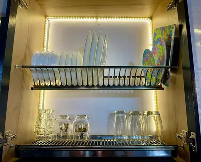 a refrigerator filled with glasses and plates on a shelf at Suitable unique design with natural light Envigado in Envigado
